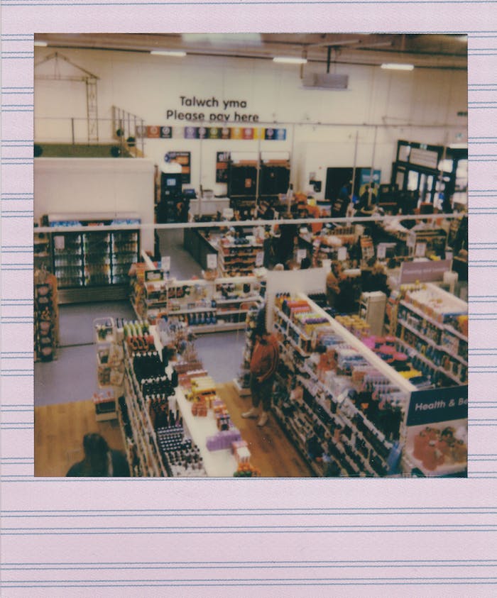 Aerial view of a bustling store captured with a vintage instant camera.